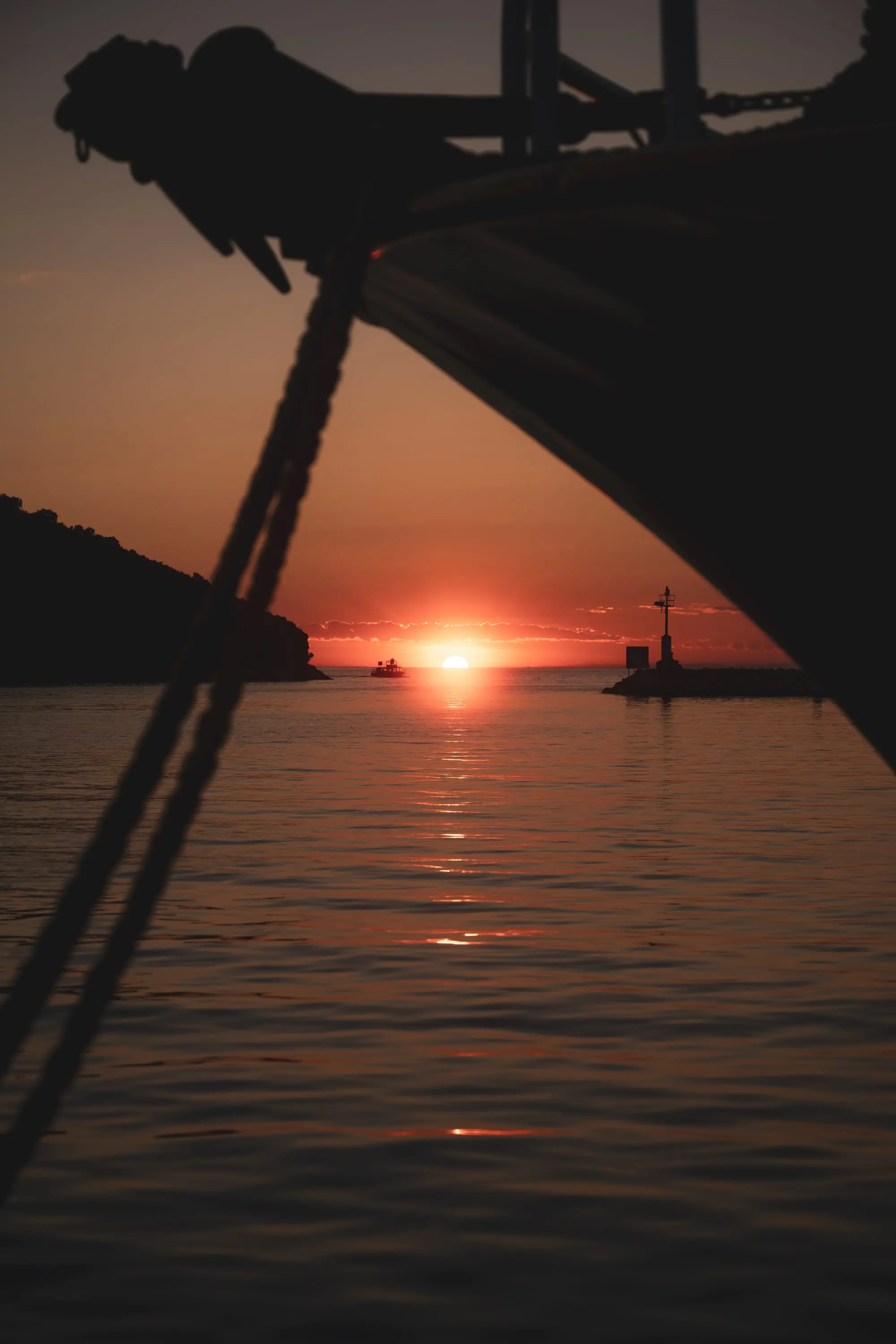 Sunset over the sea, silhouette of a pier
