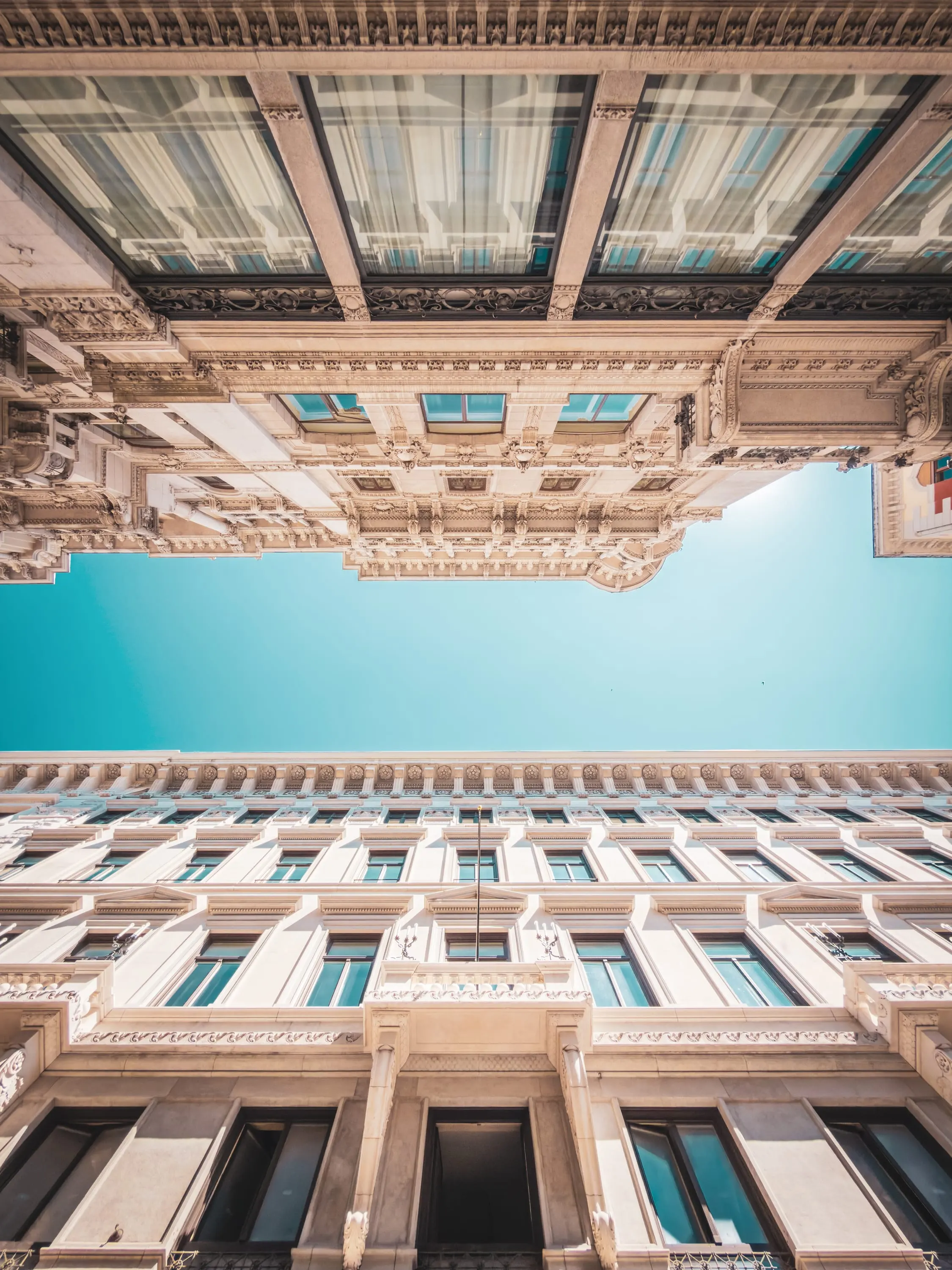 Looking up at ornate façades against a blue sky