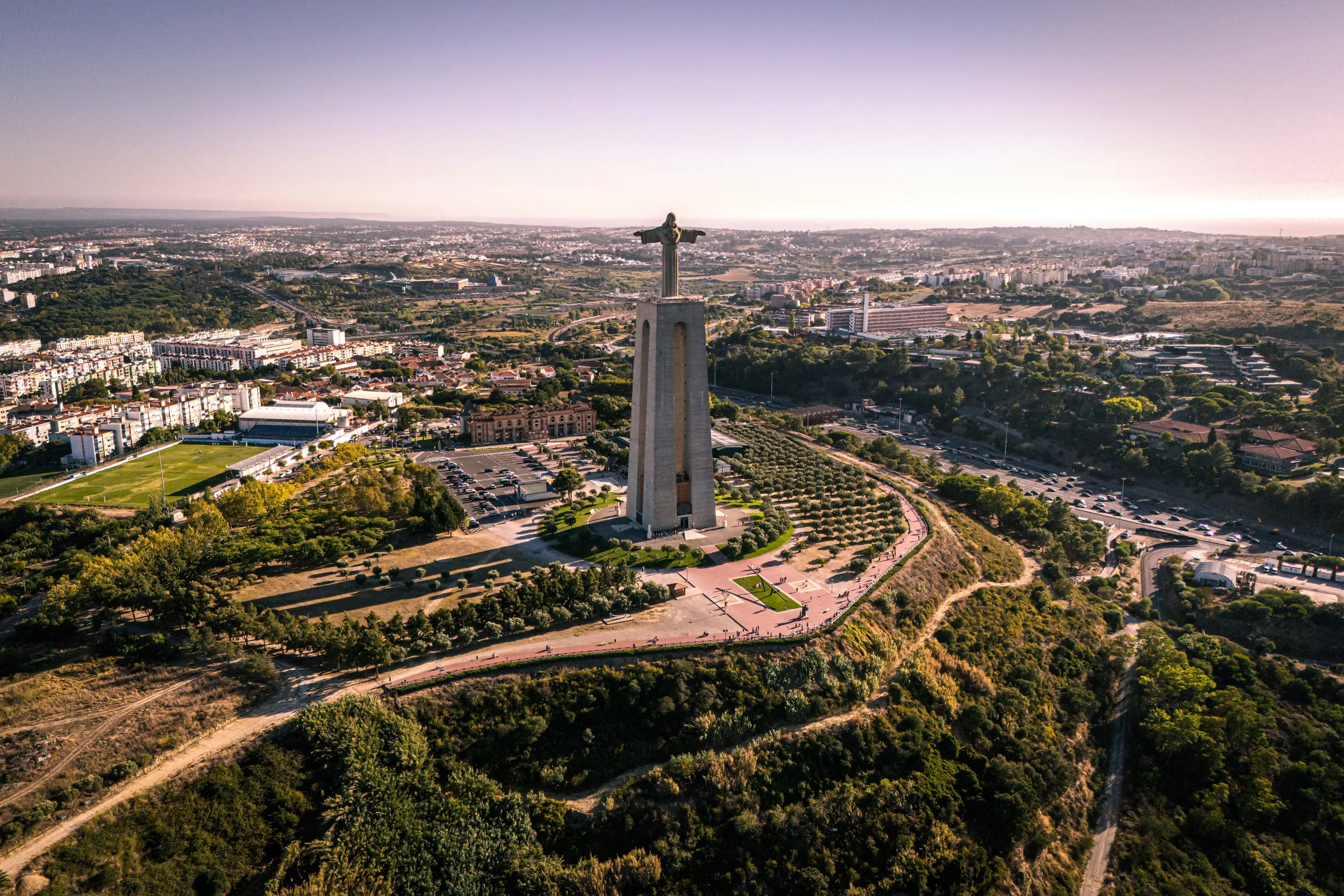 Drone view of Cristo Rei above the sprawl of Lisbon