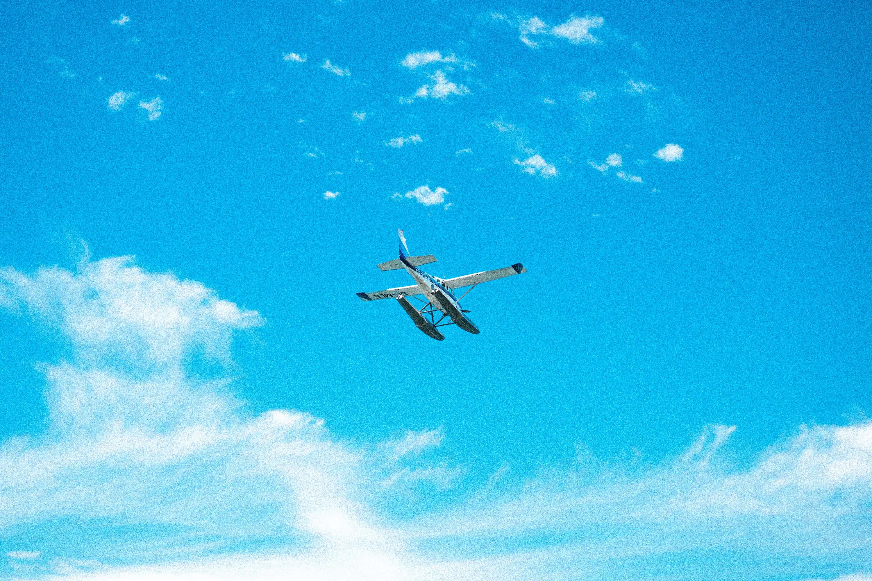 Aircraft wing above a cloud layer, backlit