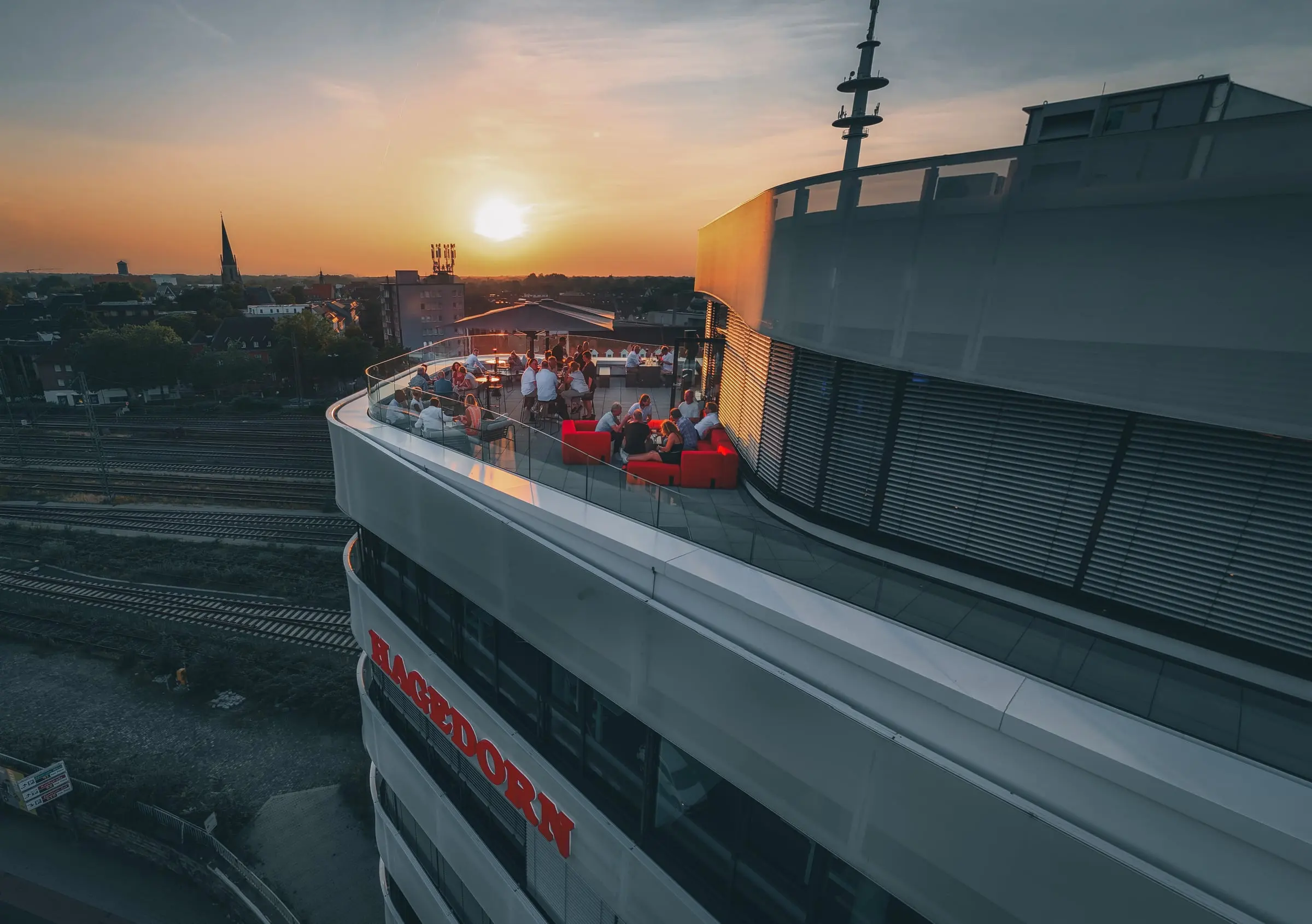 Rooftop bar above Gütersloh at sunset, from the air